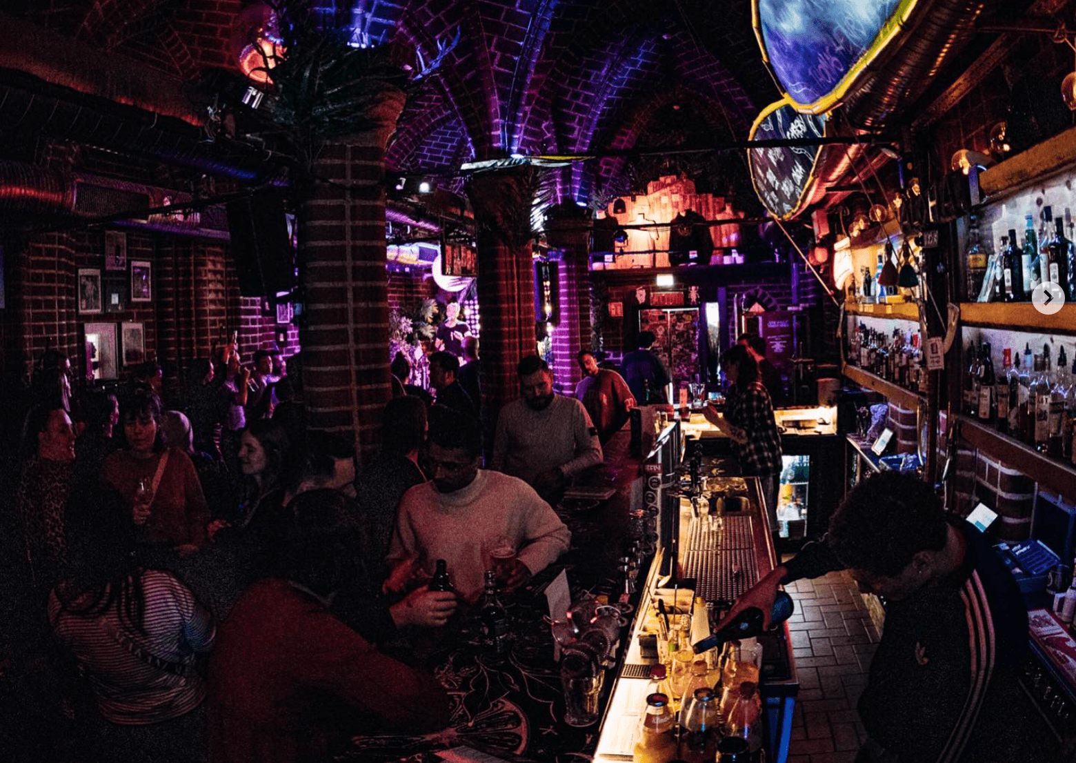 Eine Bar voller Menschen in schummerigem Licht